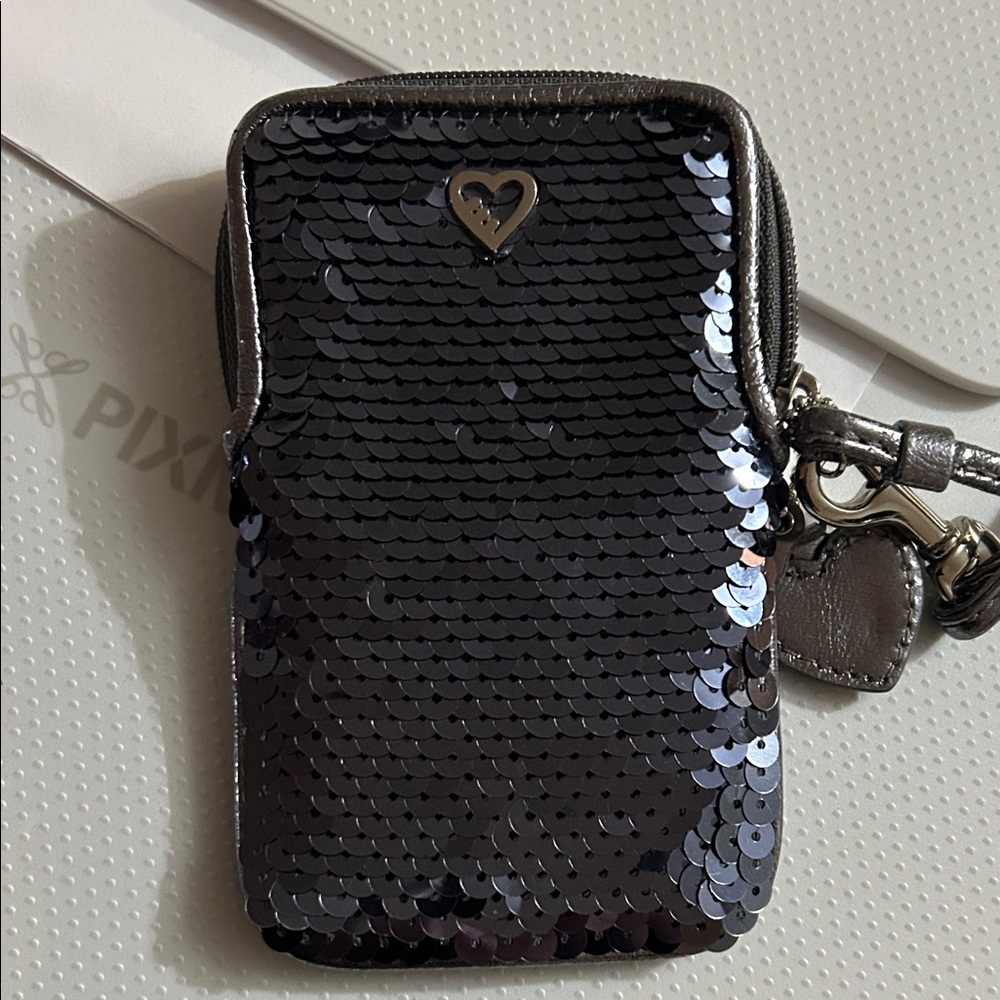 Coach wristlet is like brand new condition color is purple/ grey sequins